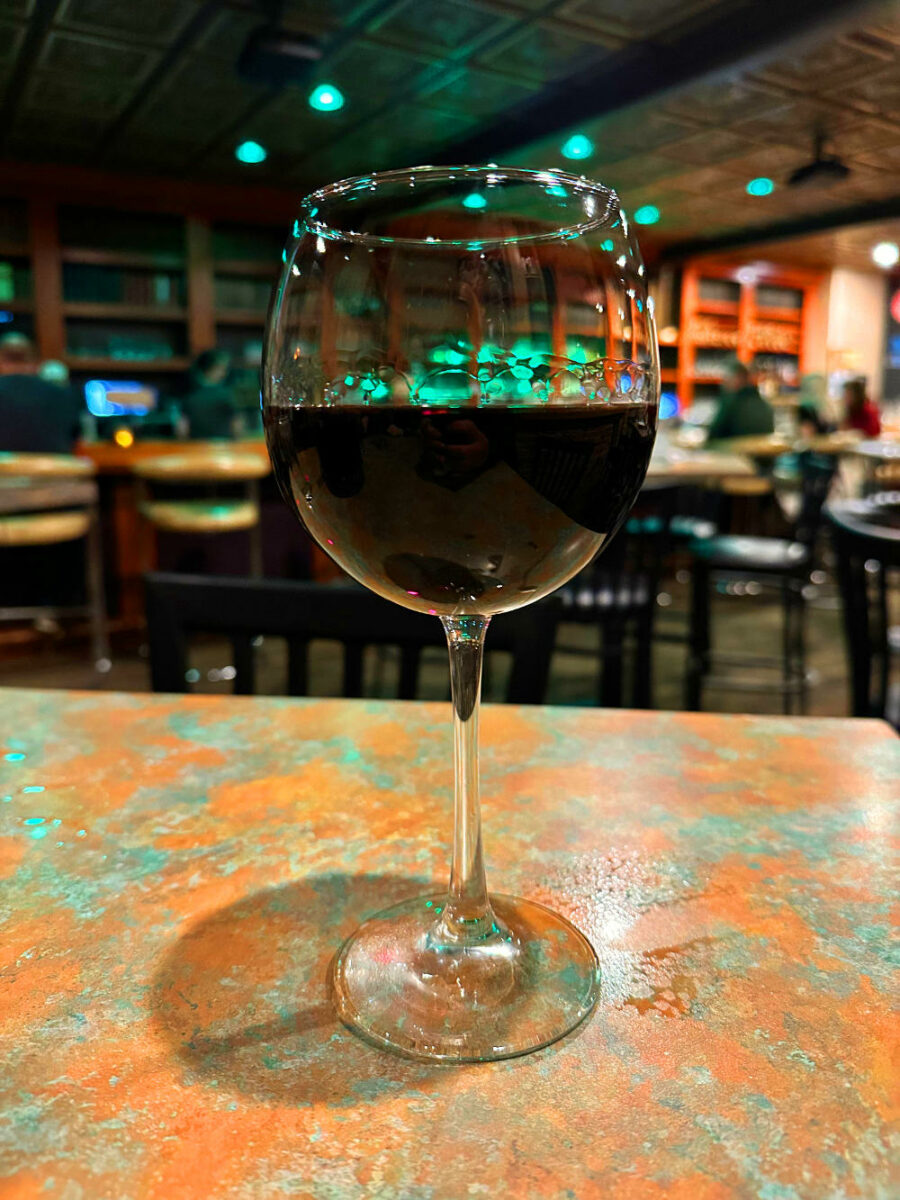 Glass of red wine on a table at the Library Bar in Houghton, Michigan